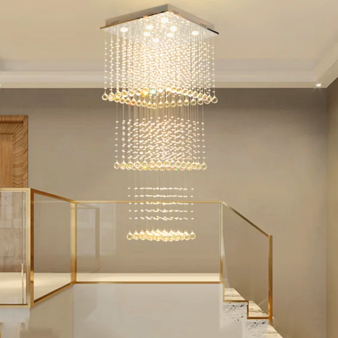 Modern chandelier hanging in a room with a staircase