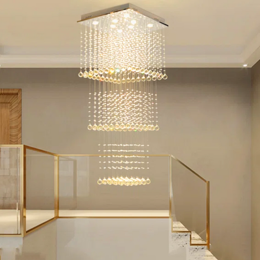 Modern chandelier hanging in a room with a staircase