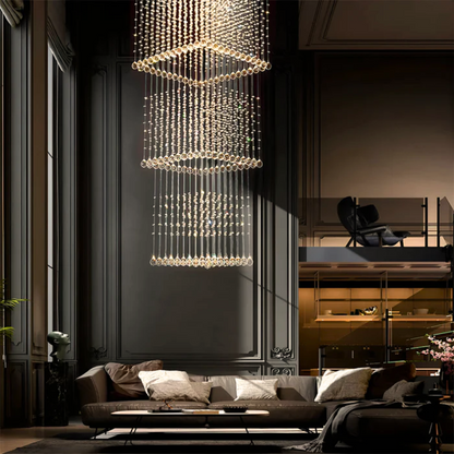 Luxurious living room with a large crystal chandelier, dark walls, and a sofa.